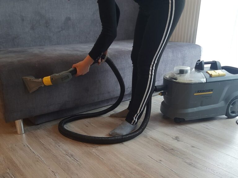 a person vacuuming a couch